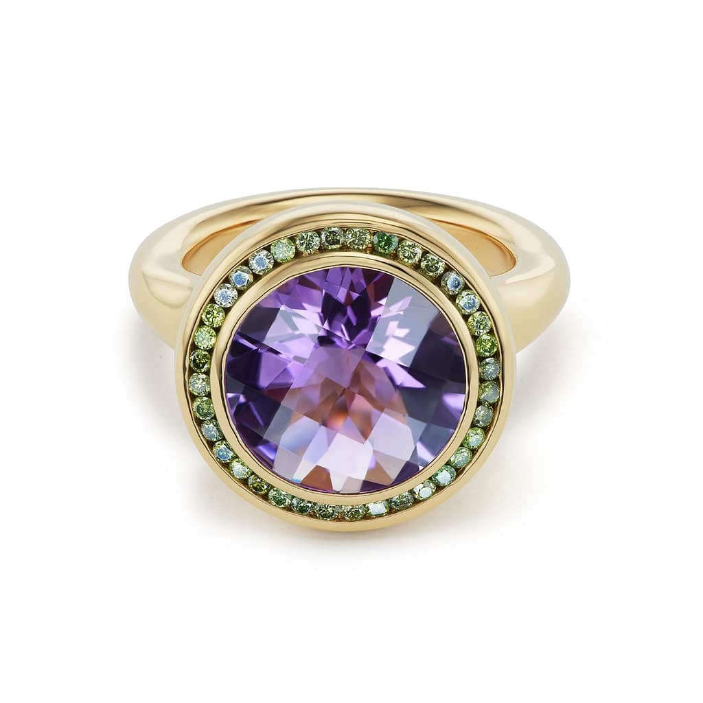 Ring made of a large round amethyst surrounded by green diamonds set in gold by Brent Neale