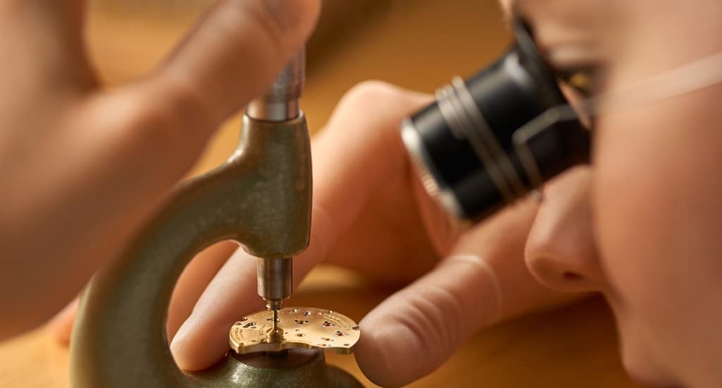 A watchmaker assembling a movement at A. Lange & Sohne