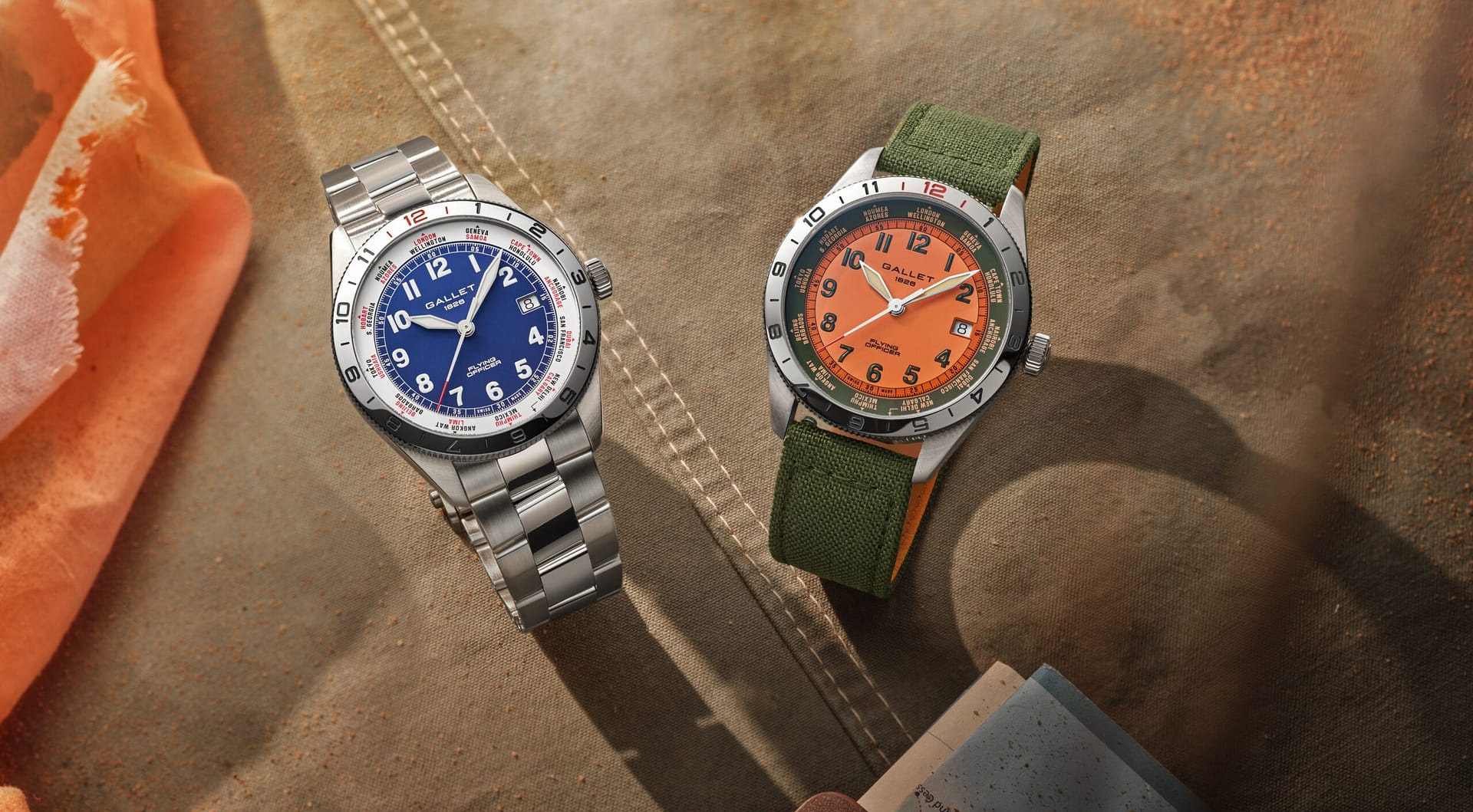 Two Gallet Flying Officer watches, one with a blue dial on a bracelet, the other with an orange dial on green strap.
