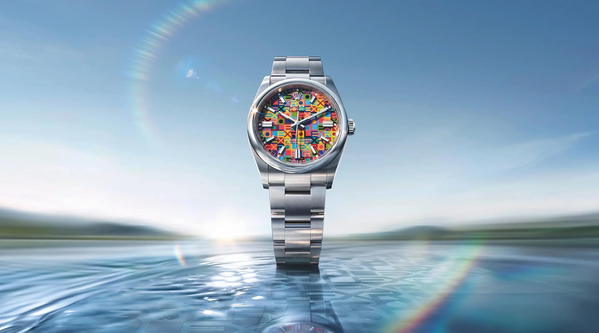 Rolex Oyster Perpetual 100th anniversary watch with multicolor jubilee design dial.