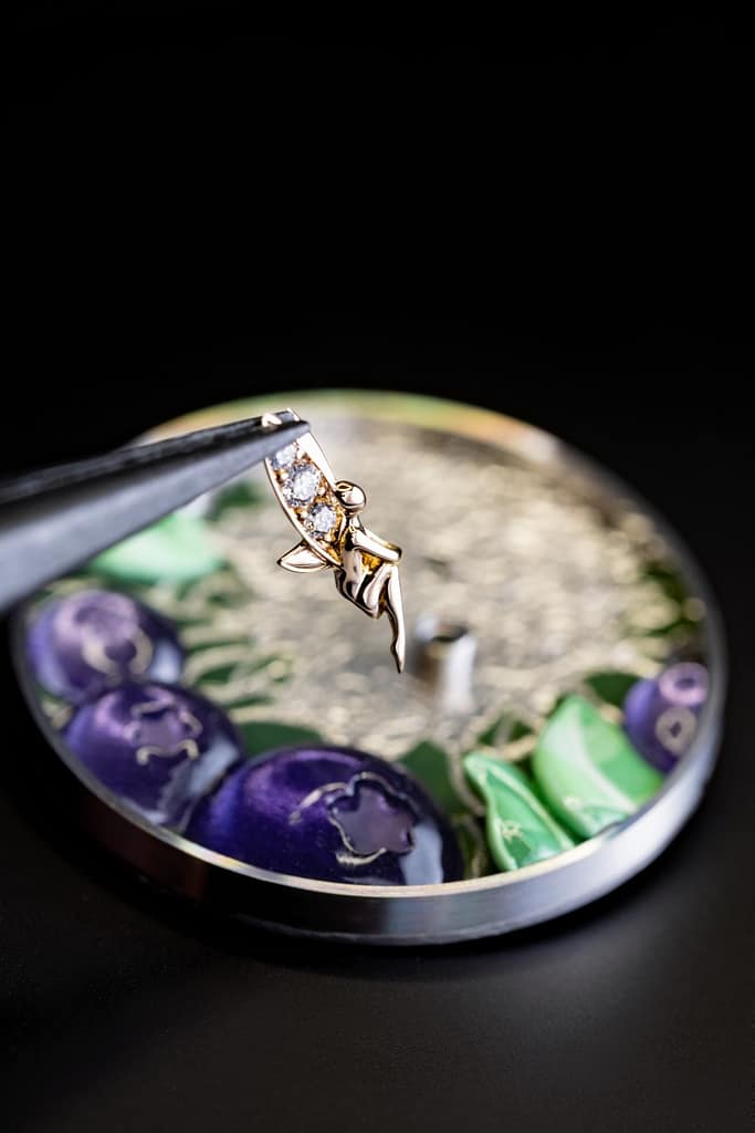 A carved gold fairy is set into the new Van Cleef & Arpels Perlée Extraordinaire Fruits Enchantés watch.