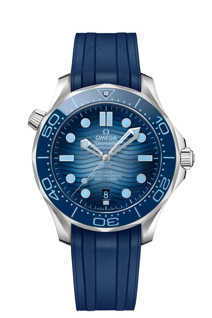 Omega Seamaster diver watch in steel with blue dial and blue rubber strap.