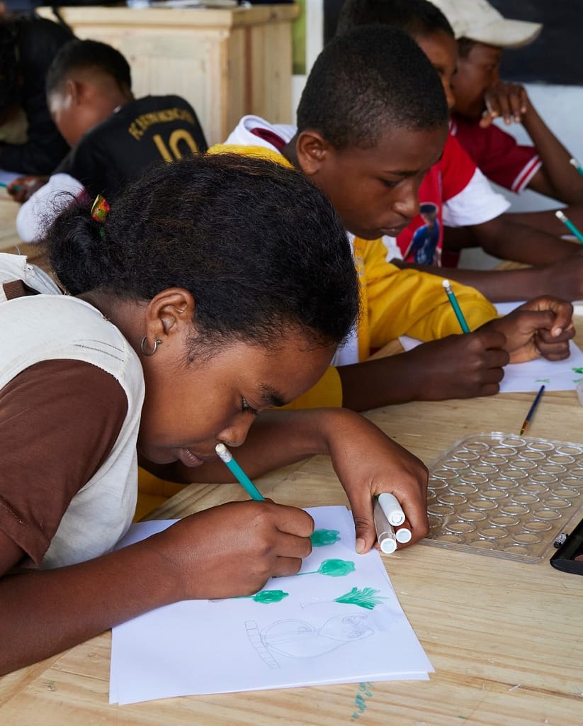 Students drawing art in a school in Madagascar